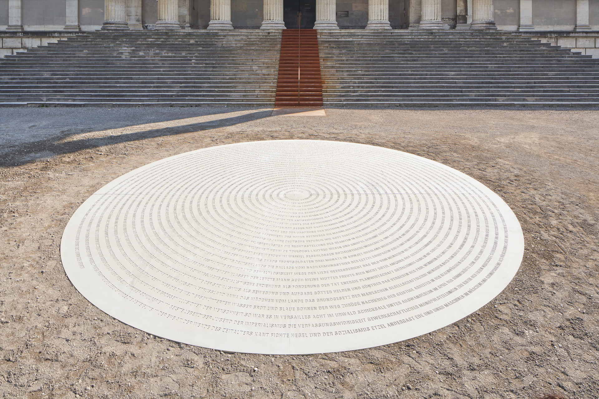 A round plate has been set in the ground ion which the titles of the burned books can be read in a spiral.